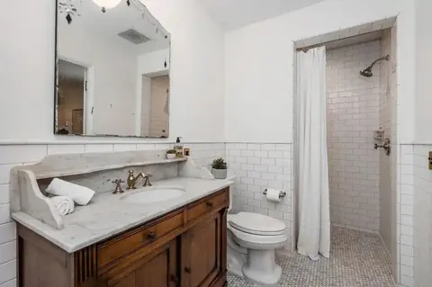 Classic bathroom with wood vanity and subway tile