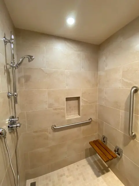 Walk-in shower with teak fold-down seat and grab bars