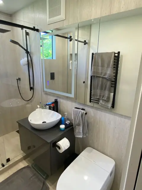 Modern bathroom with vessel sink and heated towel rail